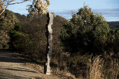 The column on a headland with scrub and hills behind