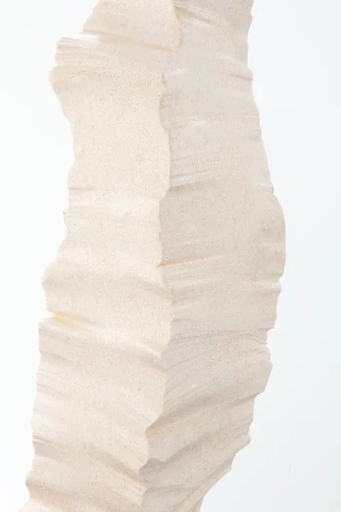 Close view of a white column’s stepped, layered edges