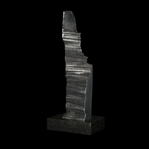 Impression 1, a cast aluminium column on a granite base against black
