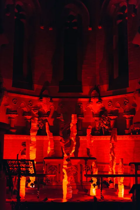 White columns lit red inside the gothic interior of St John’s Church
