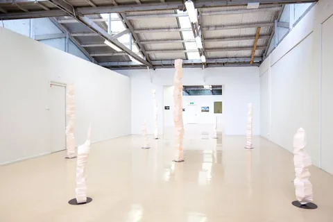 The gallery with columns spaced across the floor under skylights