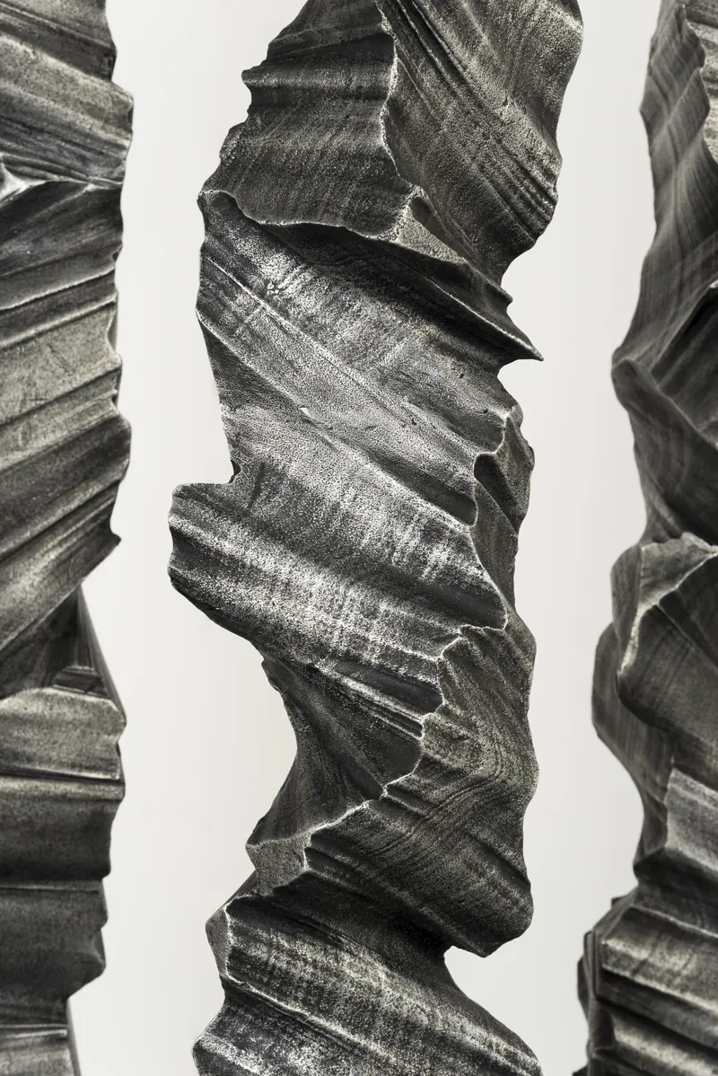 Three columns seen close together, their ridged surfaces filling the frame