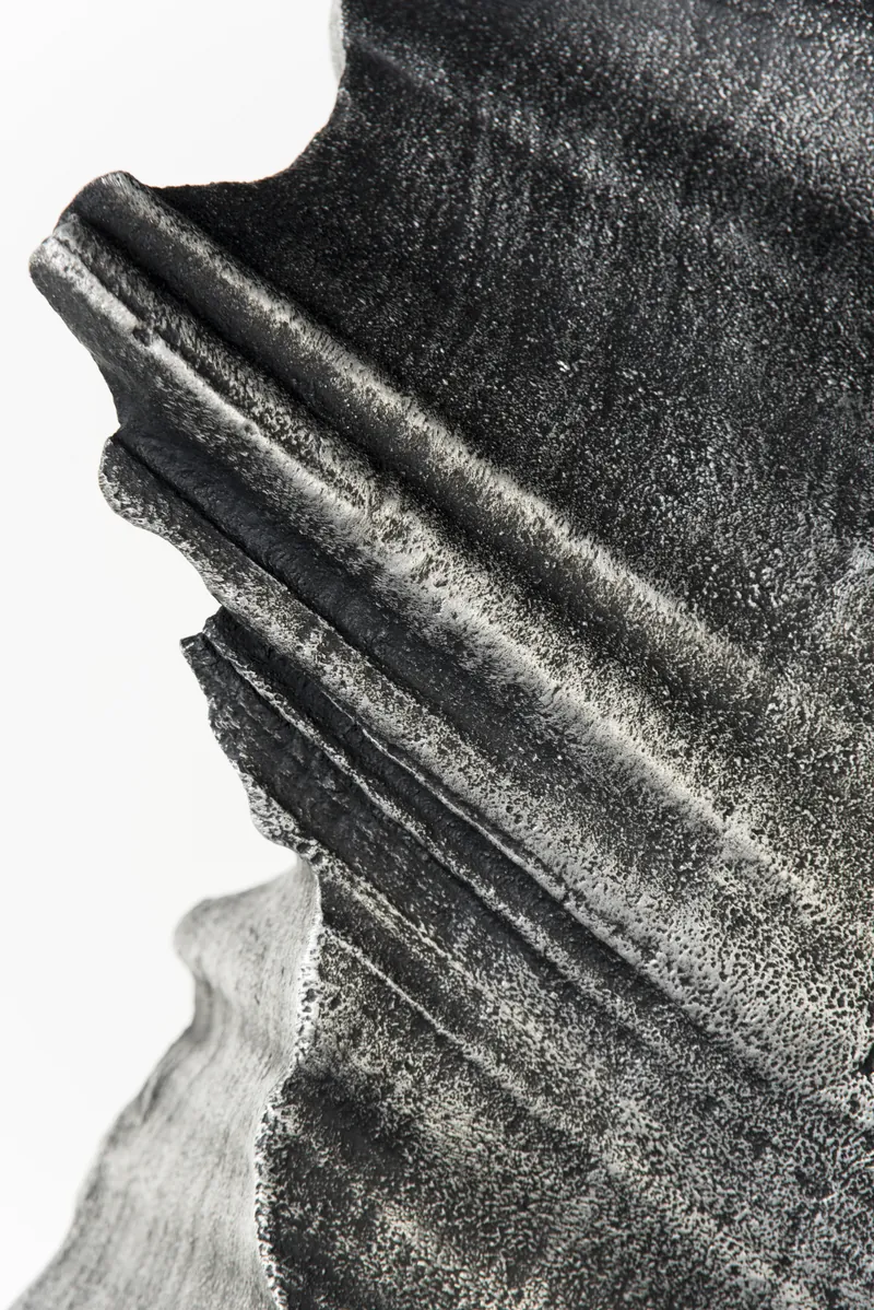 Macro view of the cast surface showing fine grain and layered ridges