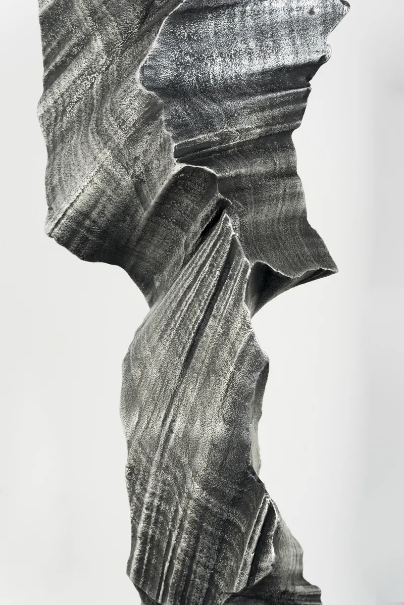 Close-up of a jagged edge where the striated surface turns